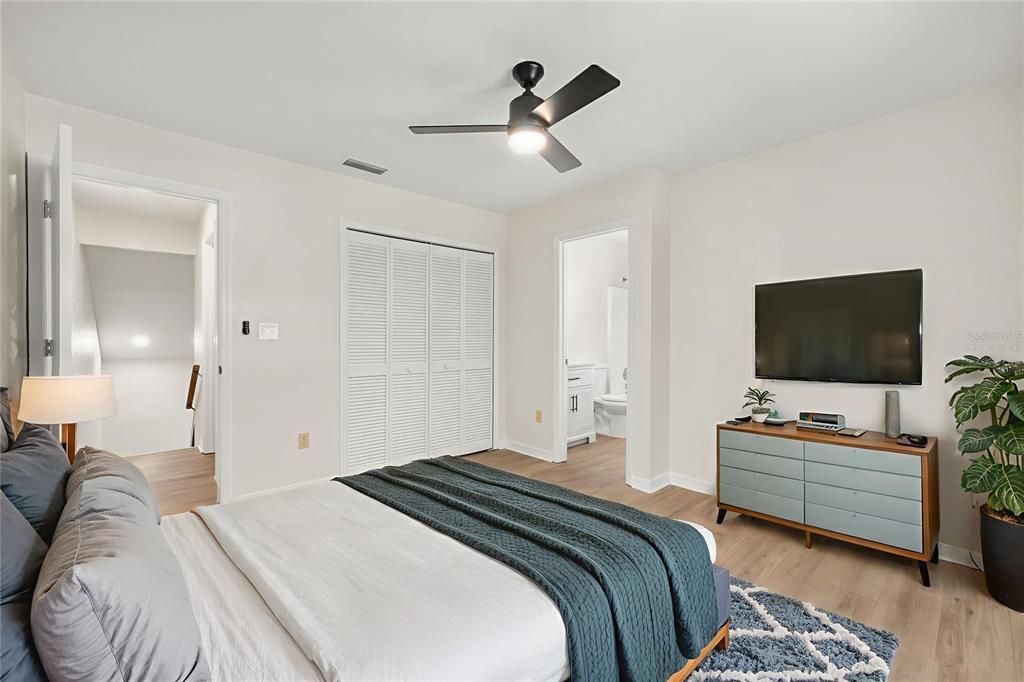 912 Southwest 57th Drive Gainesville, FL 32607 - Photo 13 of 34 a bedroom with a bed and a flat screen tv