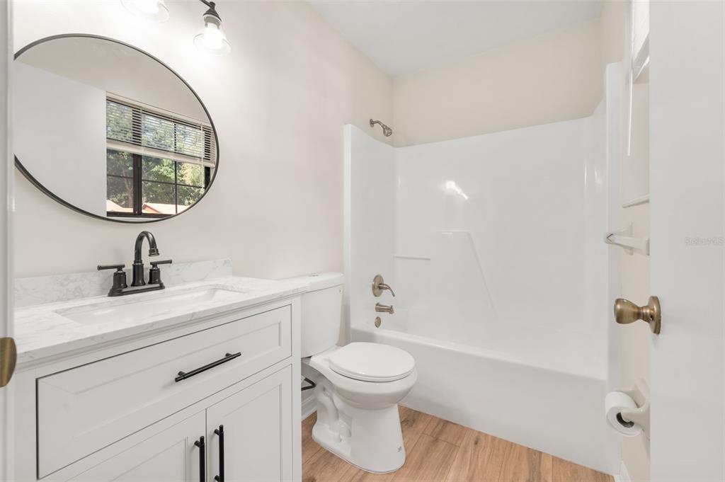 912 Southwest 57th Drive Gainesville, FL 32607 - Photo 14 of 34 a bathroom with a toilet a sink and mirror