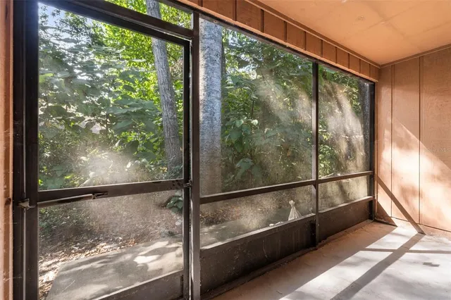 a view of a glass door with a yard from a window