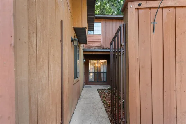 a view of a hallway with wooden walls and stairs