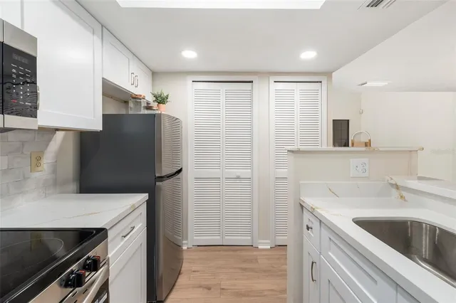 a kitchen with a sink and refrigerator