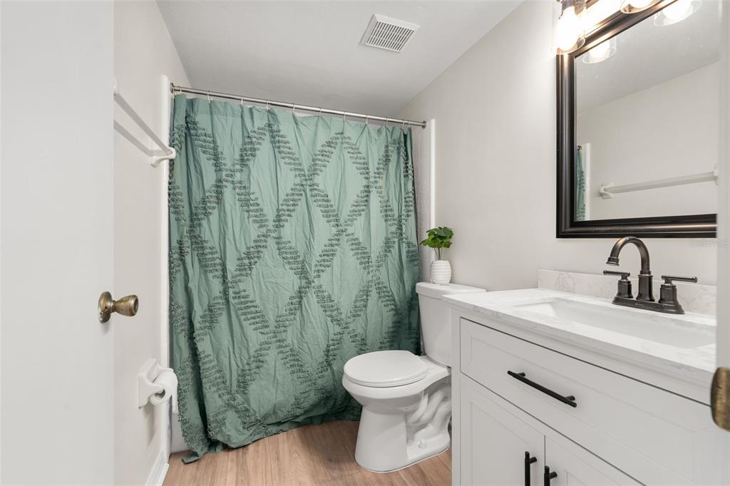 912 Southwest 57th Drive Gainesville, FL 32607 - Photo 7 of 34 a bathroom with a sink a toilet and shower