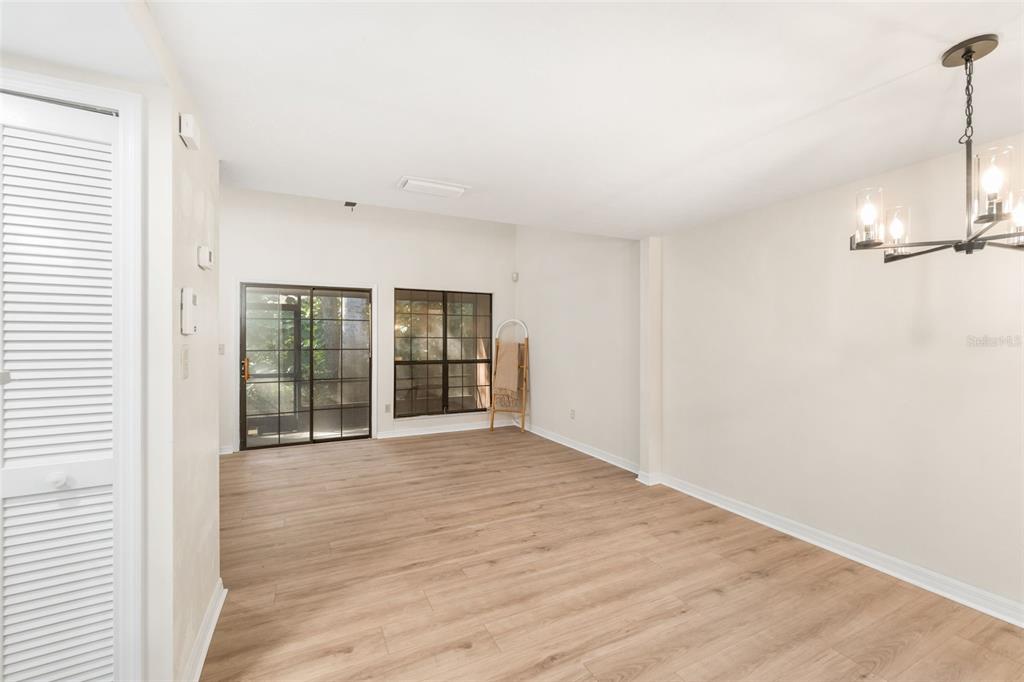 912 Southwest 57th Drive Gainesville, FL 32607 - Photo 9 of 34 a view of an empty room with wooden floor and a window