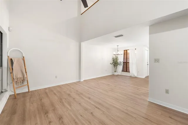 a view of a livingroom with wooden floor and a window