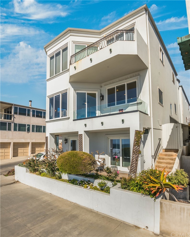 2220 The Strand Manhattan Beach, CA 90266 - Photo 11 of 44 a front view of a building with a lot of flower plants