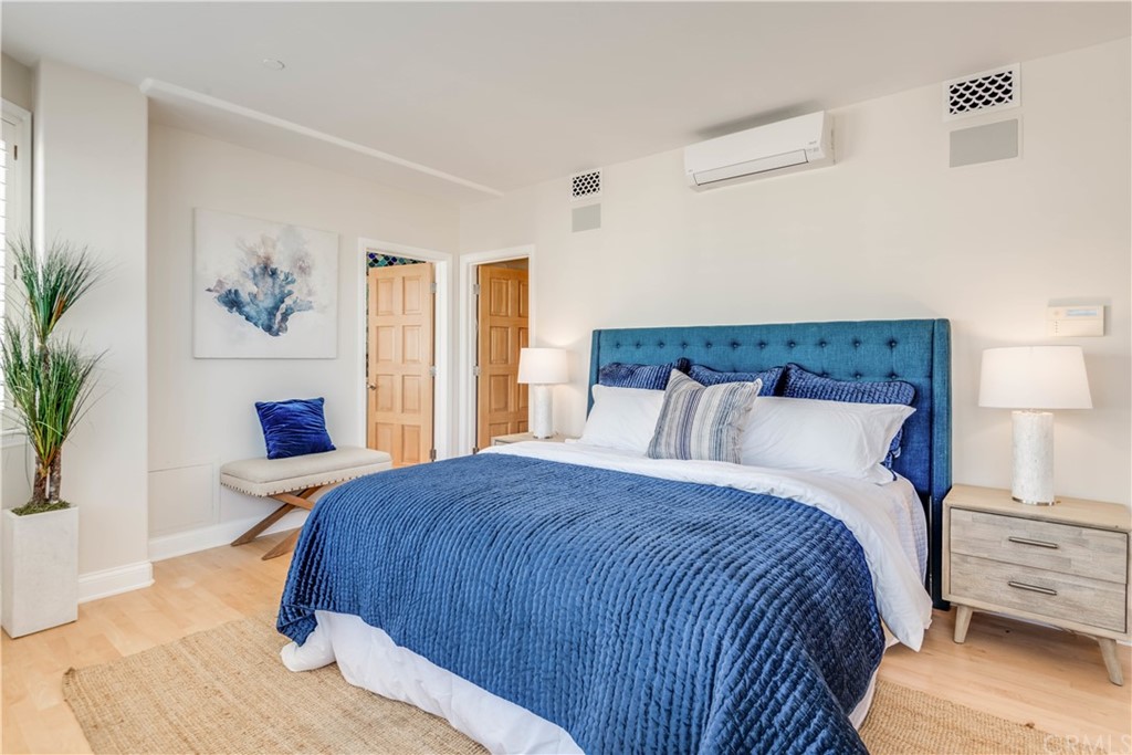 2220 The Strand Manhattan Beach, CA 90266 - Photo 30 of 44 a bedroom with a bed and wooden floor