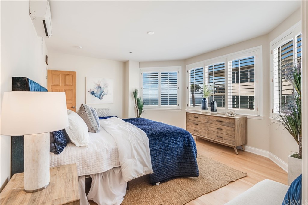 2220 The Strand Manhattan Beach, CA 90266 - Photo 31 of 44 a bedroom with a bed and wooden floor