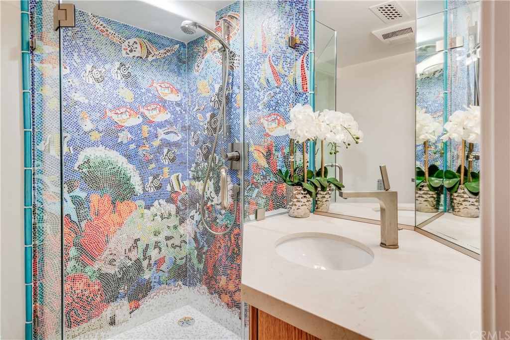 2220 The Strand Manhattan Beach, CA 90266 - Photo 37 of 44 a bathroom with a sink a mirror and a shower curtain