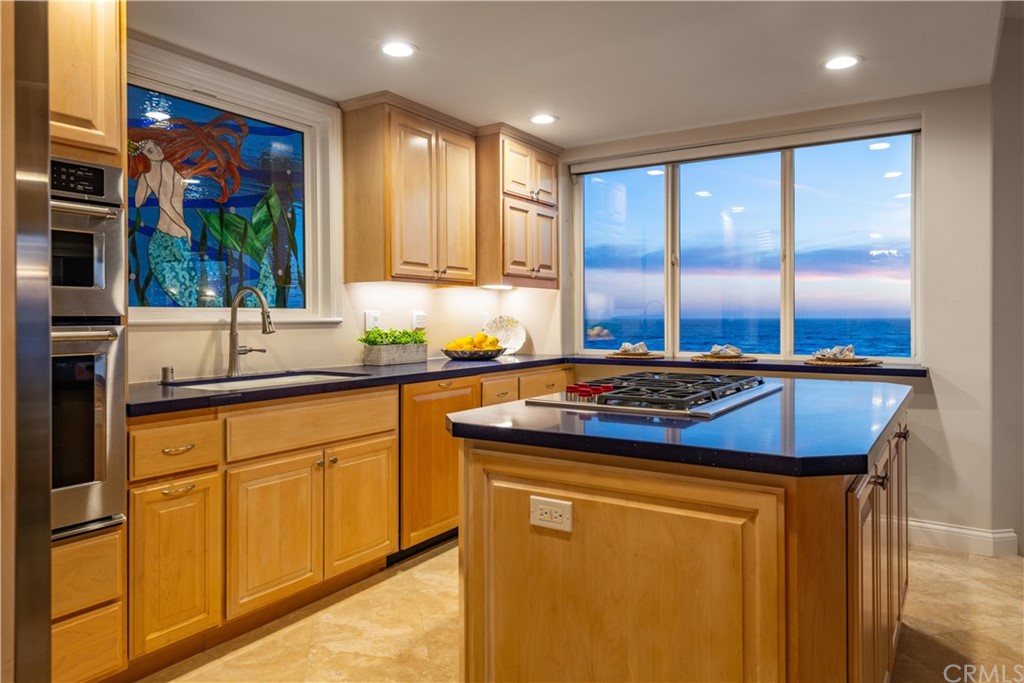 2220 The Strand Manhattan Beach, CA 90266 - Photo 4 of 44 a kitchen with stainless steel appliances granite countertop a stove a sink and a refrigerator