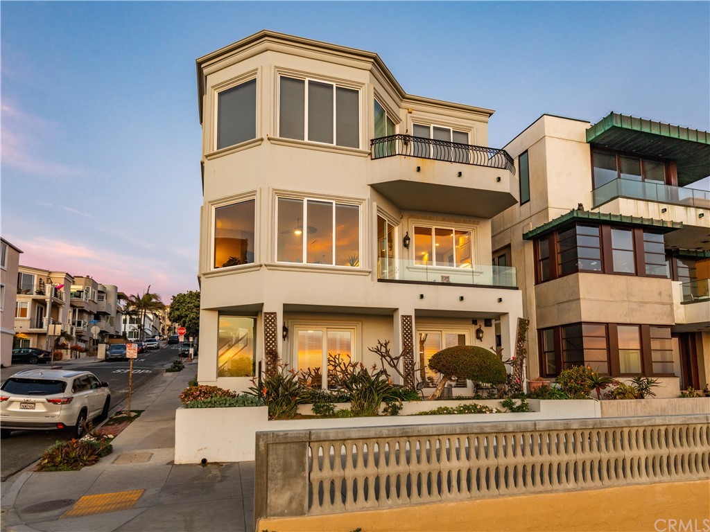 2220 The Strand Manhattan Beach, CA 90266 - Photo 7 of 44 a front view of a residential apartment building with a yard