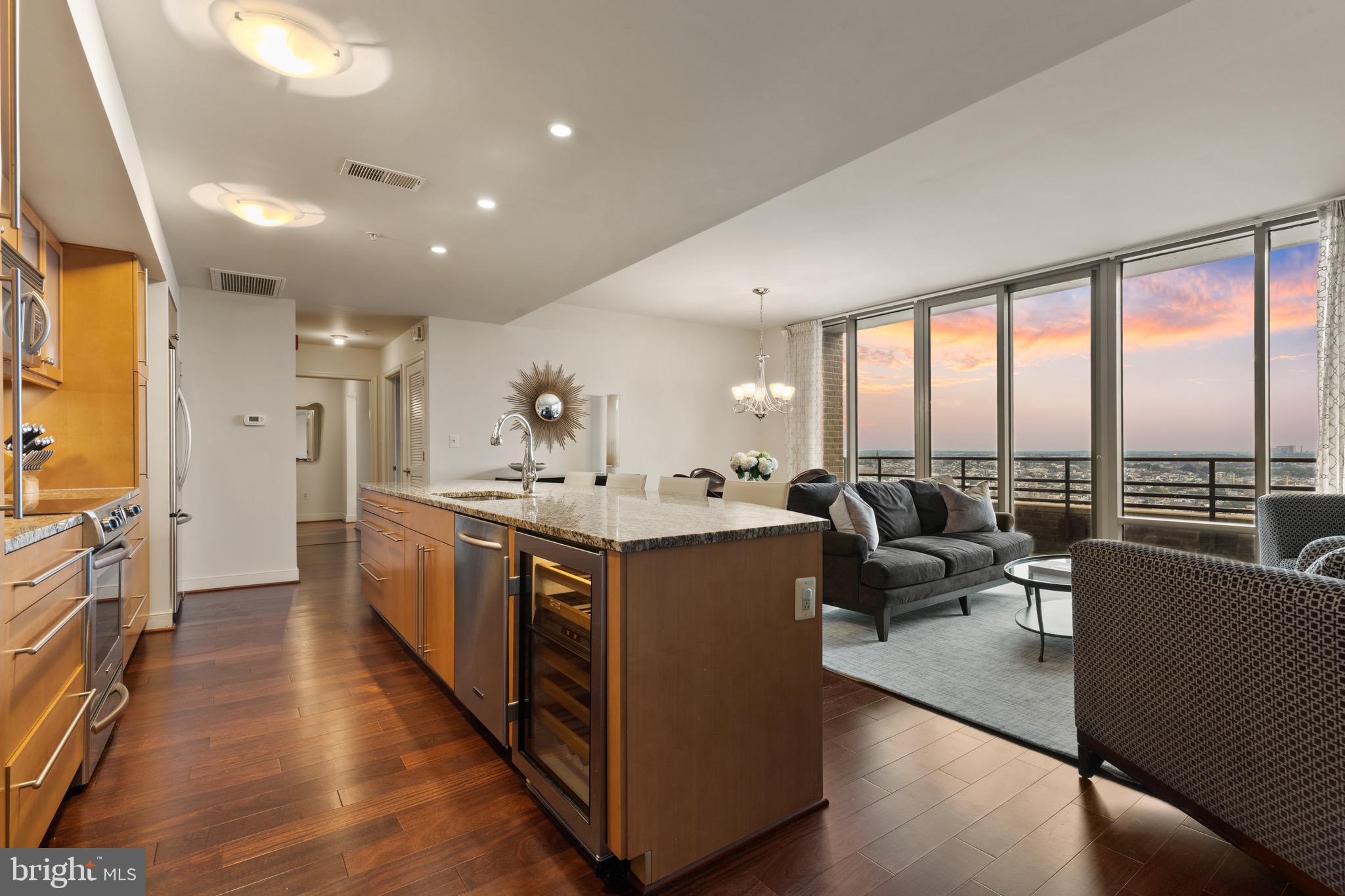 a large living room with stainless steel appliances granite countertop a couch and a view of living room