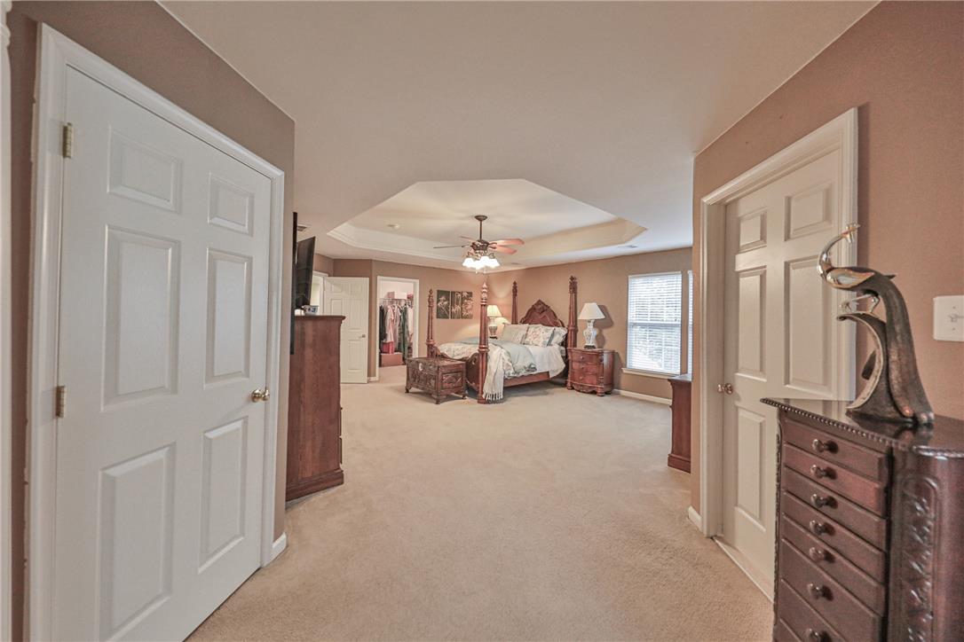 138 Clover Hollow Road Easton, PA 18045 - Photo 39 of 95 A spacious primary bedroom featuring a ceiling fan and plush carpeting, perfect for relaxation.