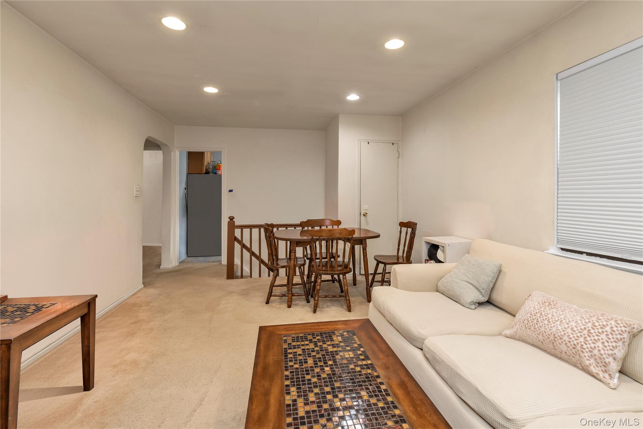 73-47 217th Street, Unit 364A2 Queens, NY 11364 - Photo 4 of 12 a living room with furniture and a rug