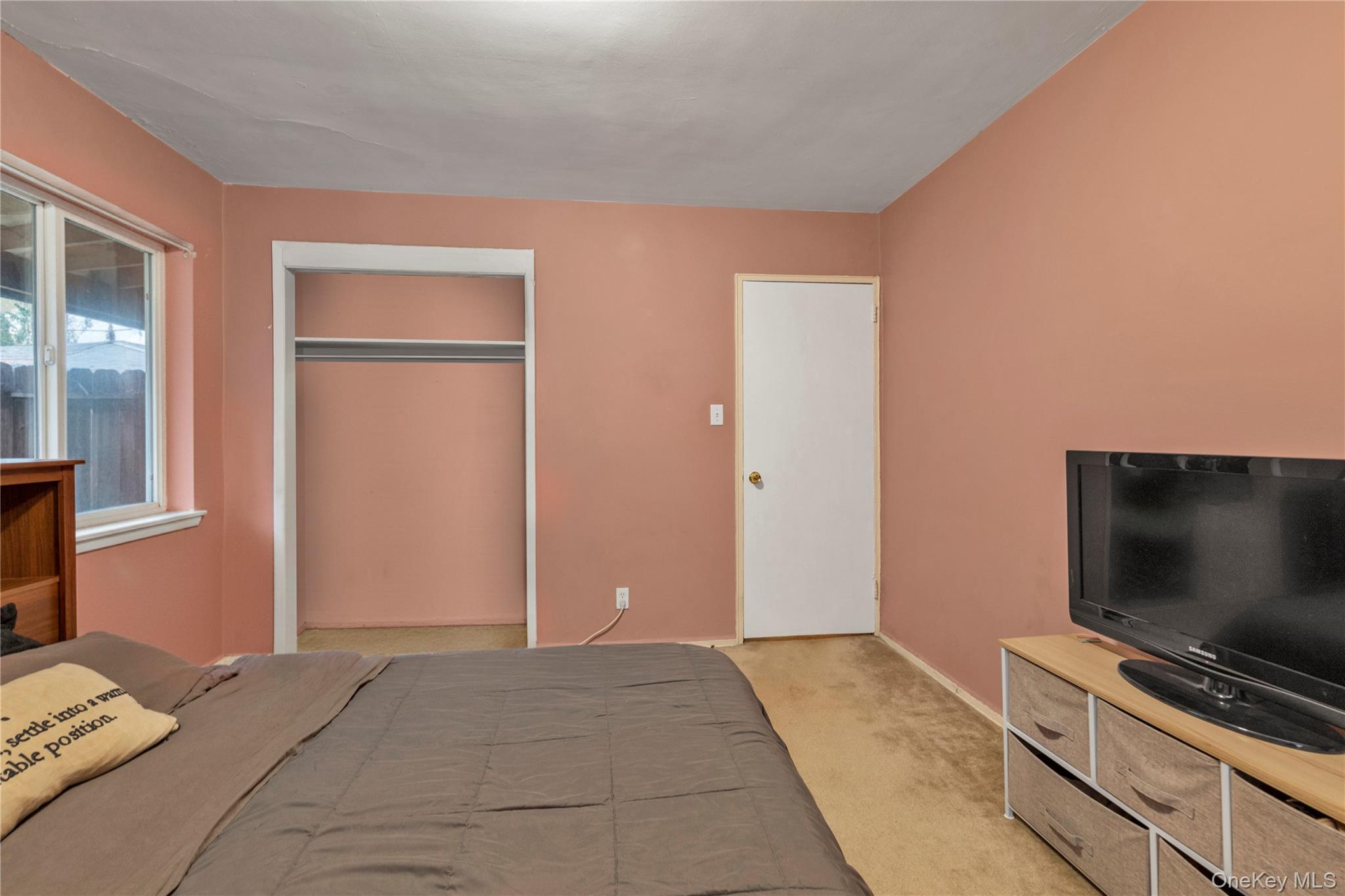 73-47 217th Street, Unit 364A2 Queens, NY 11364 - Photo 8 of 12 a bedroom with a bed and a flat screen tv