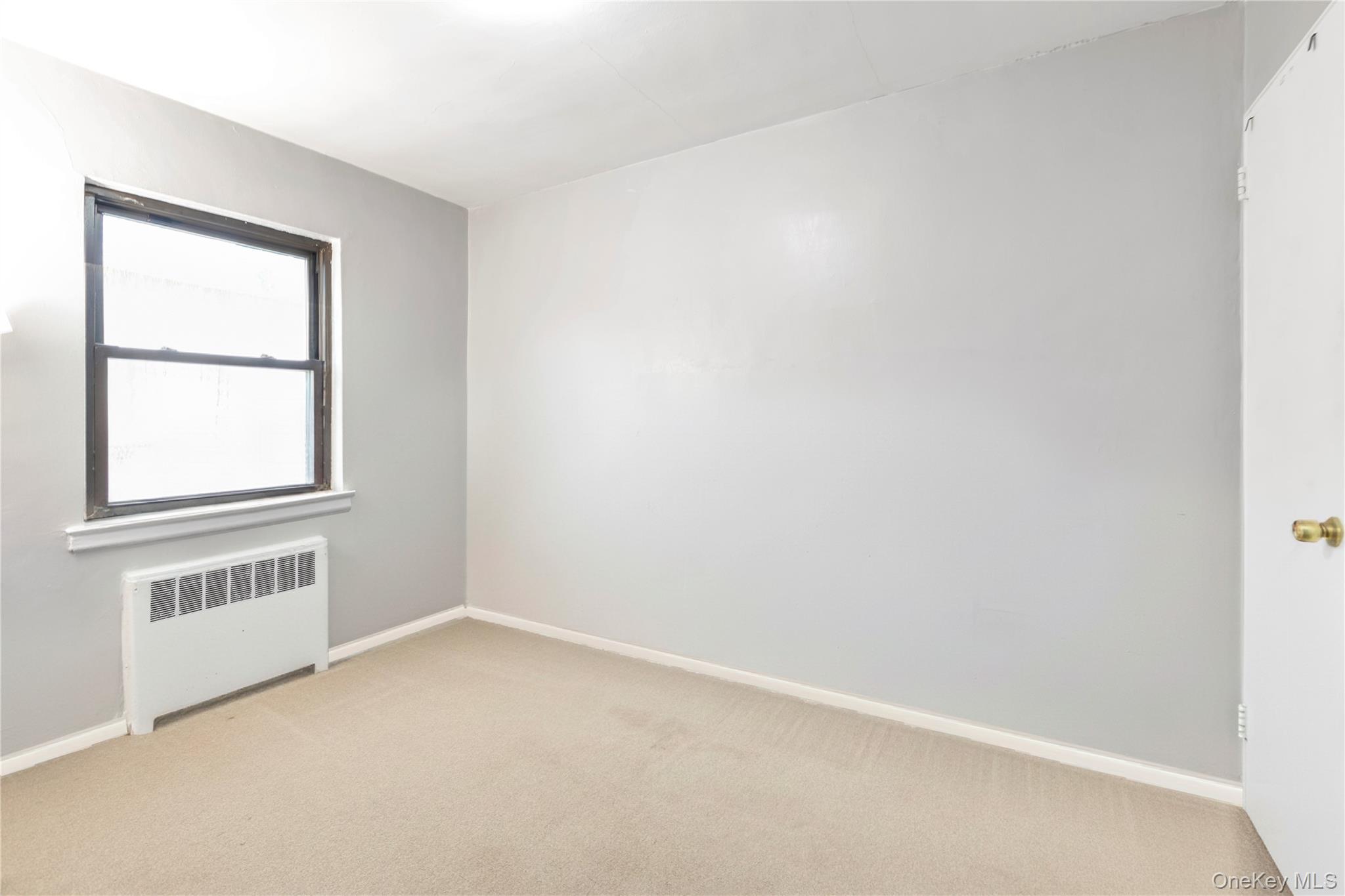 73-47 217th Street, Unit 364A2 Queens, NY 11364 - Photo 9 of 12 an empty room with a window