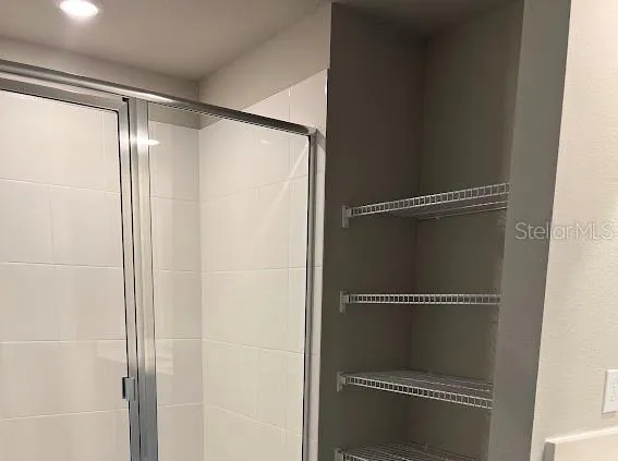 a bathroom with a glass shower door
