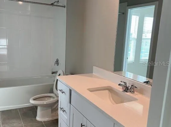 a bathroom with a sink toilet vanity and bathtub