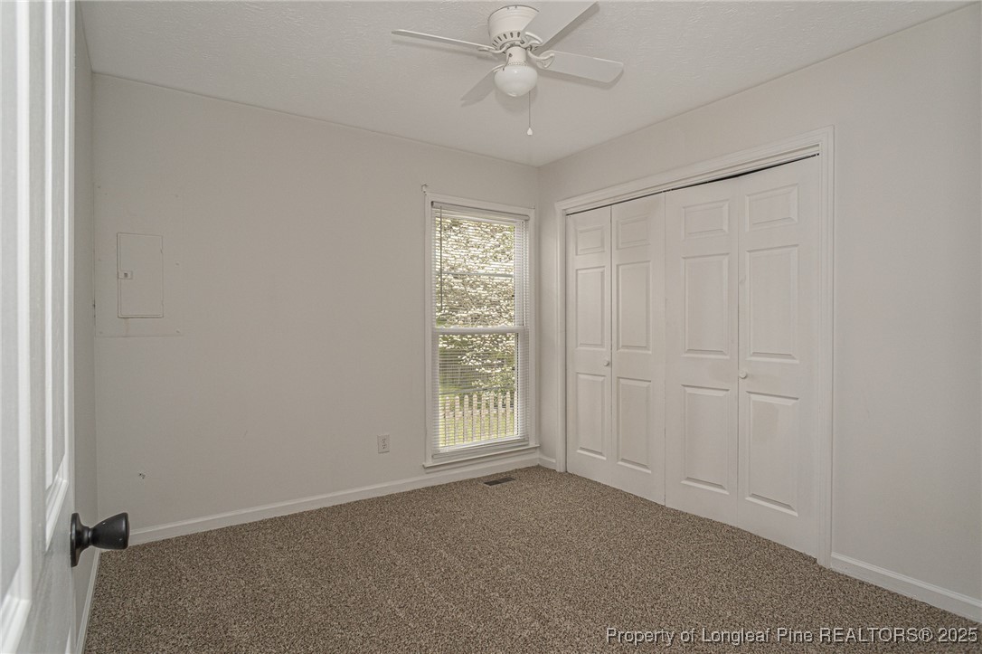 6576 Applewhite Road Fayetteville, NC 28304 - Photo 14 of 35 an empty room with windows and fan