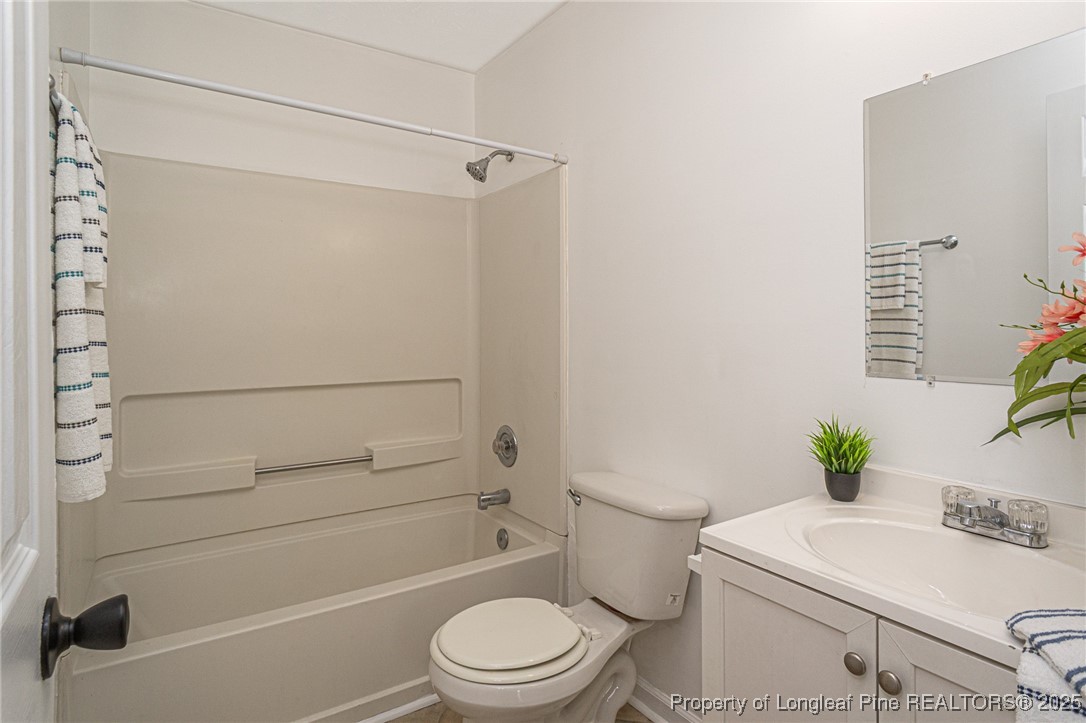 6576 Applewhite Road Fayetteville, NC 28304 - Photo 25 of 35 a bathroom with a sink a toilet and shower