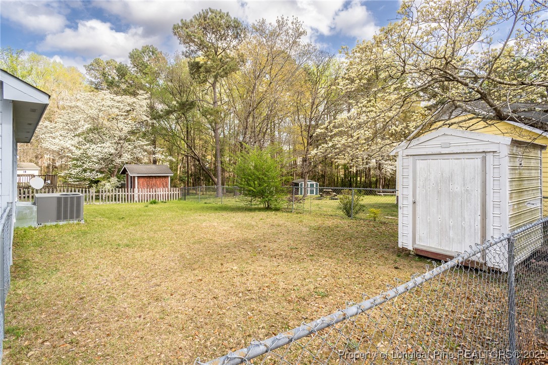 6576 Applewhite Road Fayetteville, NC 28304 - Photo 30 of 35 a view of a house with backyard and tree