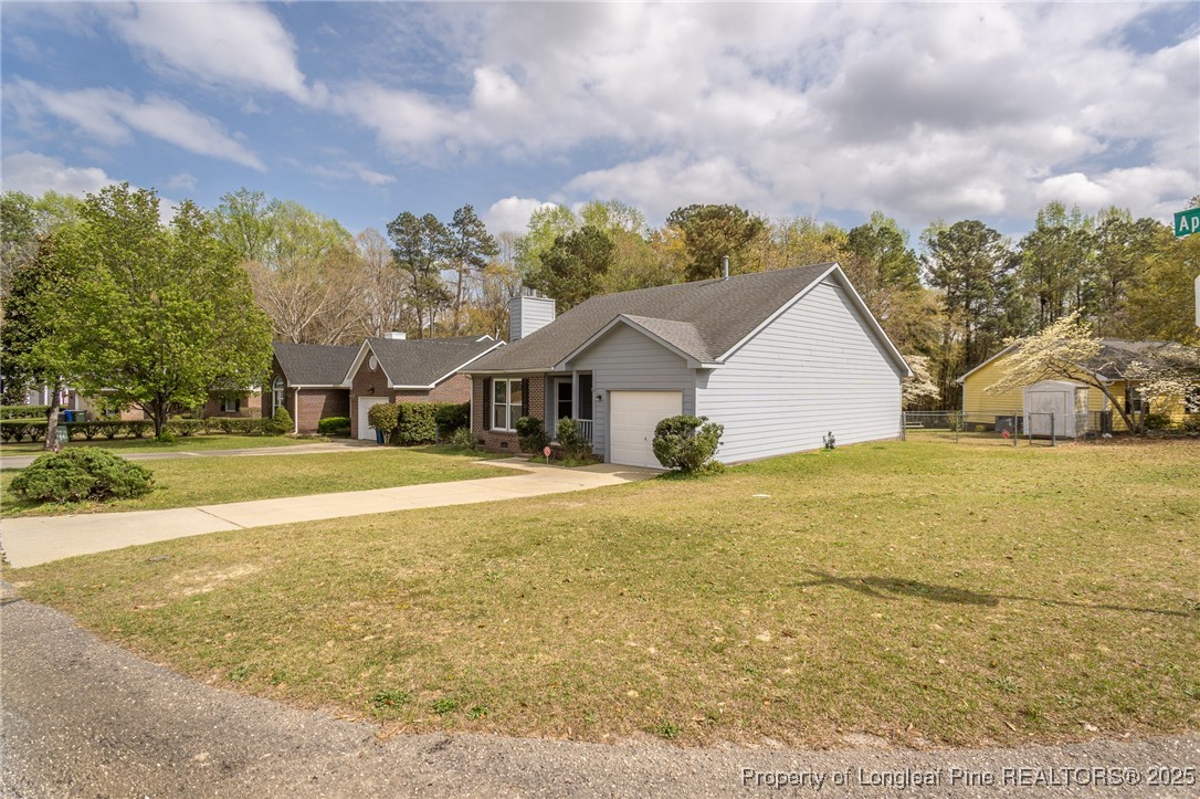 6576 Applewhite Road Fayetteville, NC 28304 - Photo 34 of 35 a view of a house with a yard and garage