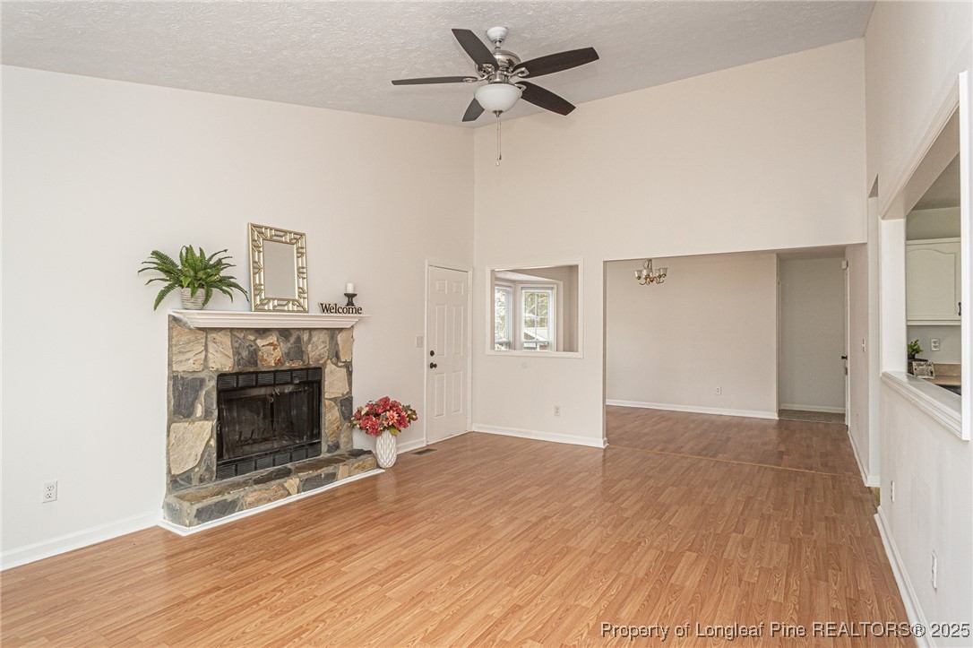 6576 Applewhite Road Fayetteville, NC 28304 - Photo 4 of 35 a view of an empty room with wooden floor fireplace and a window