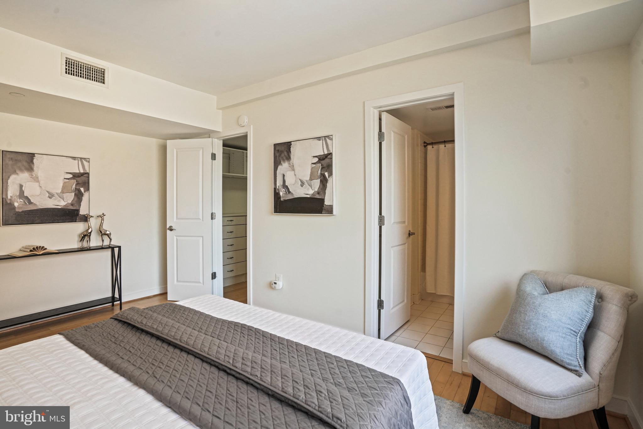 420 16th Street Southeast, Unit 103 Washington, DC 20003 - Photo 10 of 16 a bedroom with a bed and a chair