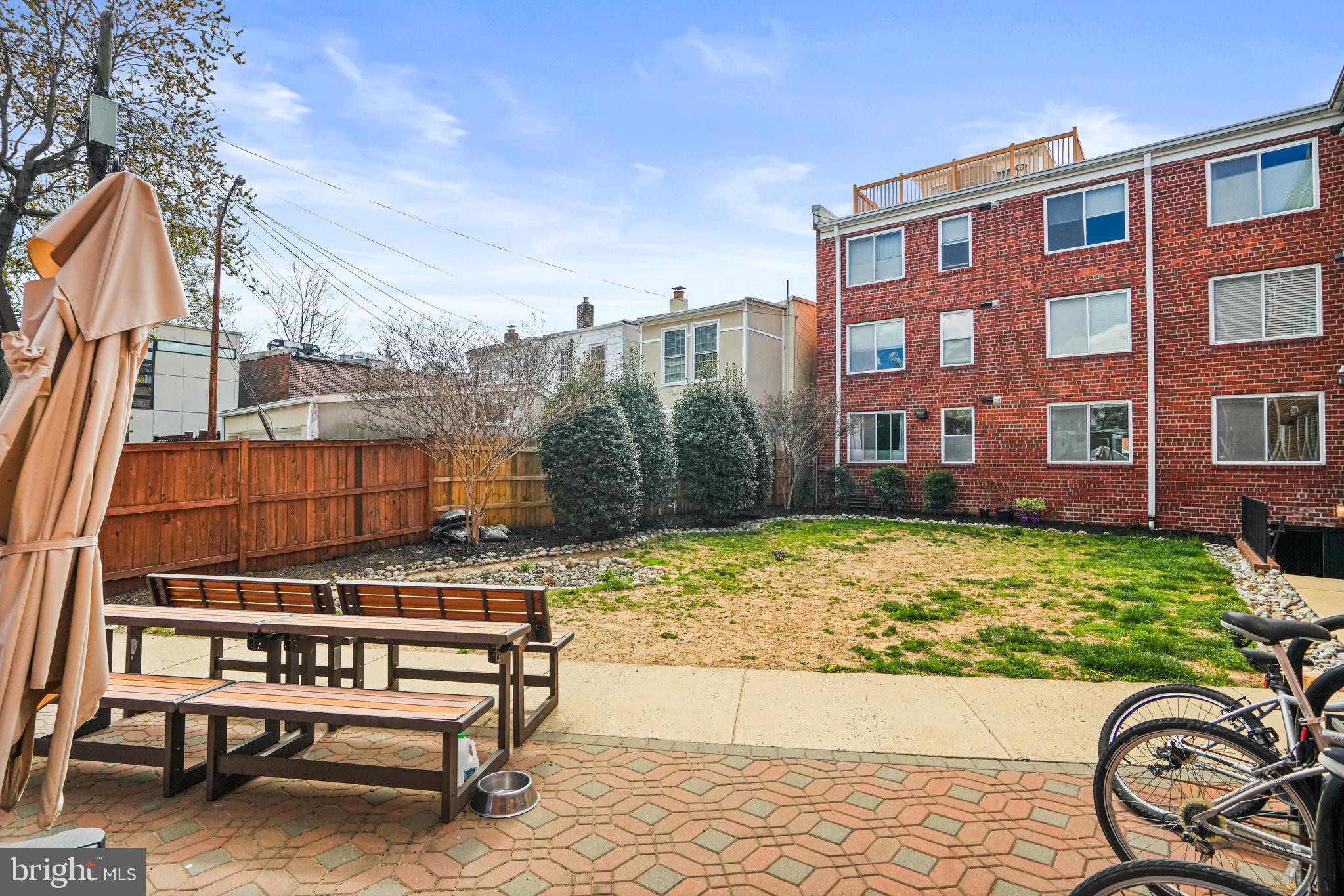 420 16th Street Southeast, Unit 103 Washington, DC 20003 - Photo 15 of 16 a backyard of a house with barbeque oven table and chairs