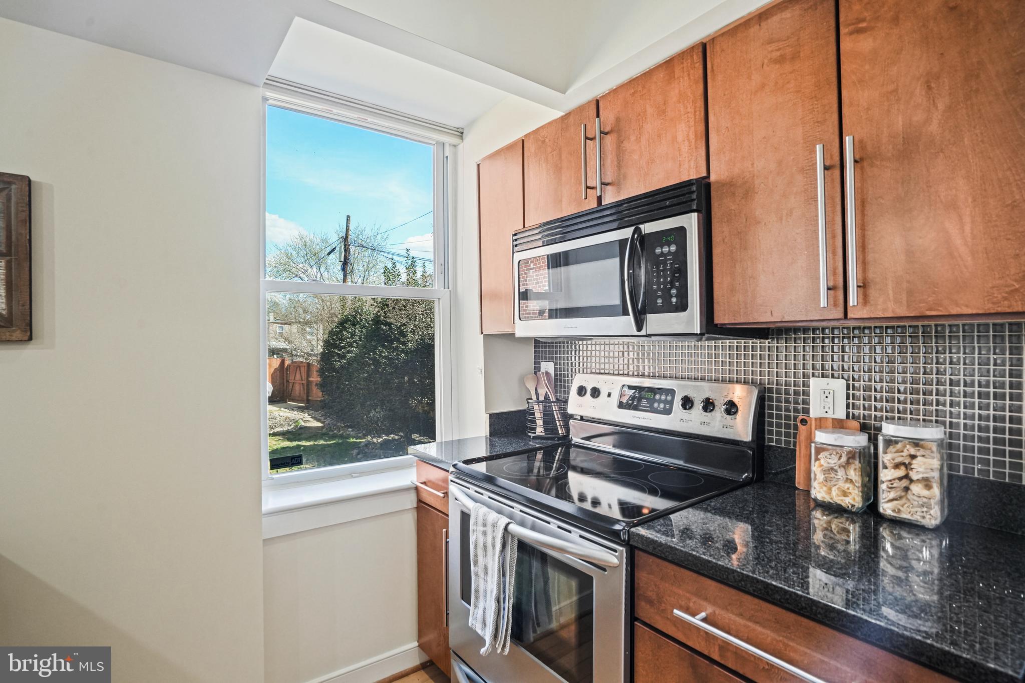 420 16th Street Southeast, Unit 103 Washington, DC 20003 - Photo 7 of 16 a kitchen with a stove microwave and cabinets