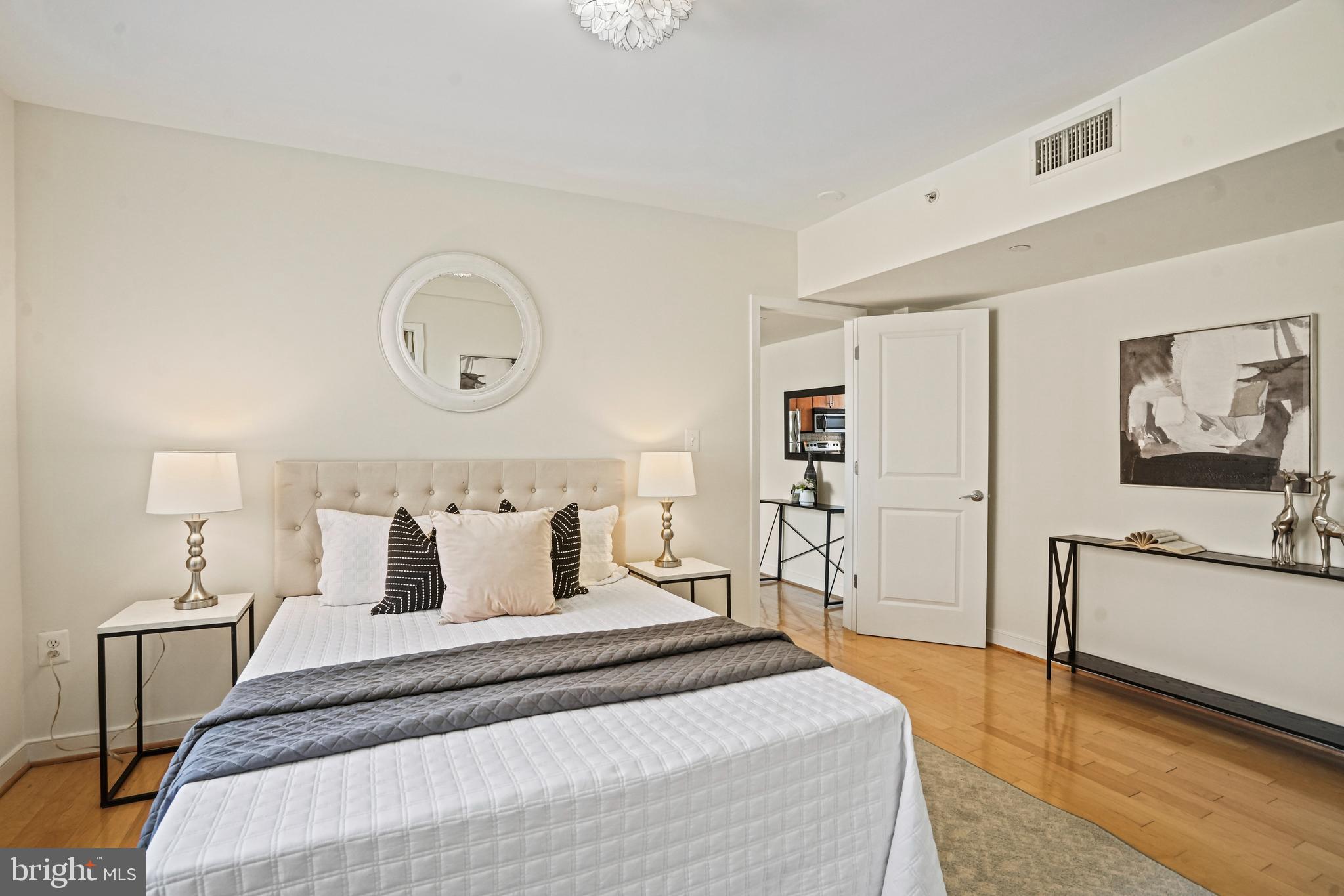 420 16th Street Southeast, Unit 103 Washington, DC 20003 - Photo 9 of 16 a bedroom with bed and cabinets