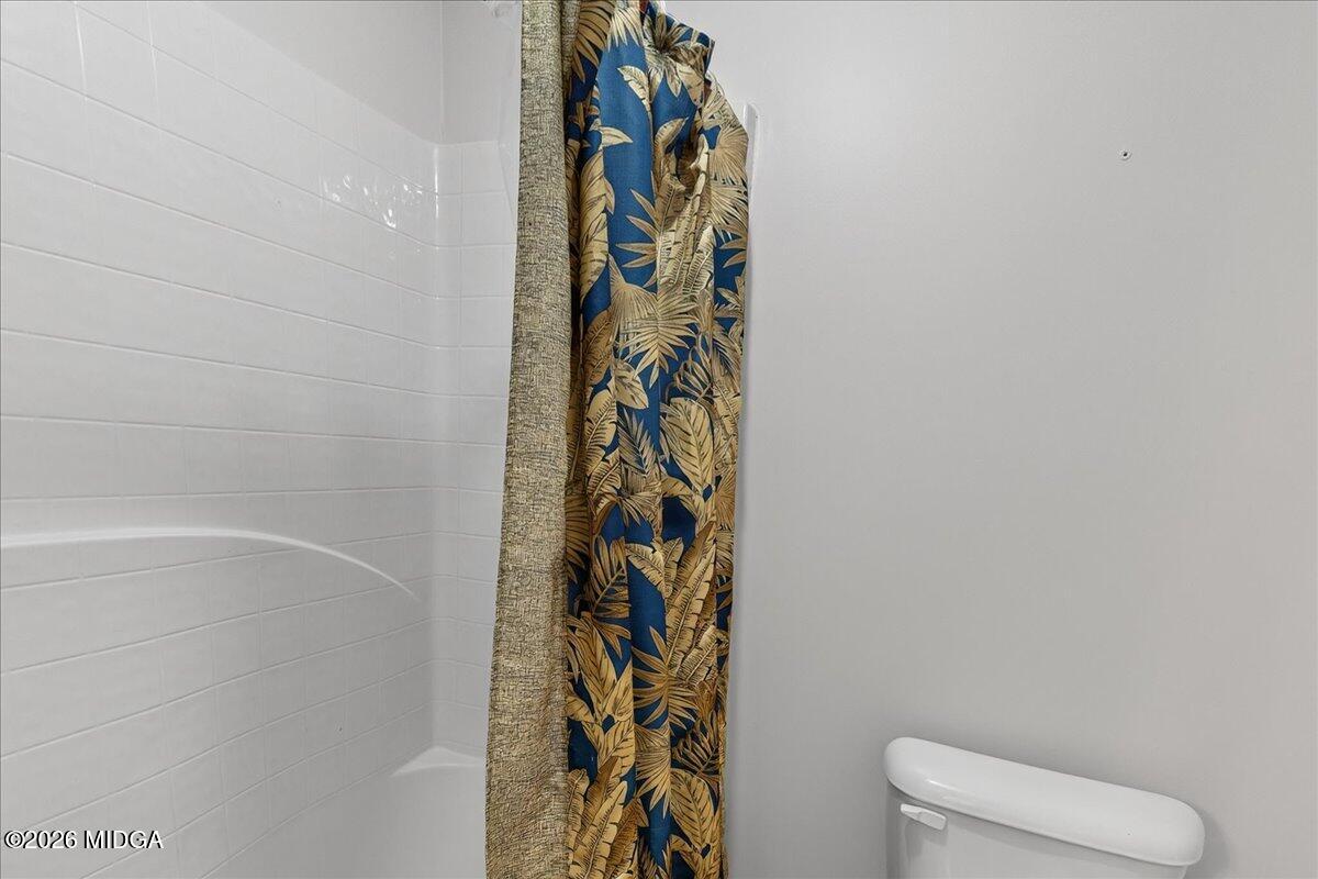 518 River Overlook Forsyth, GA 31029 - Photo 53 of 96 a bathroom with a toilet and a shower curtain