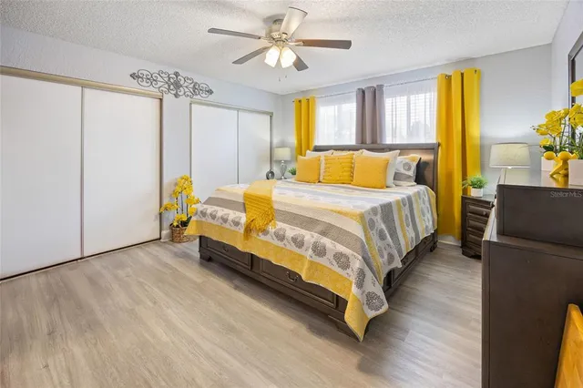 a bedroom with a bed dresser and a window