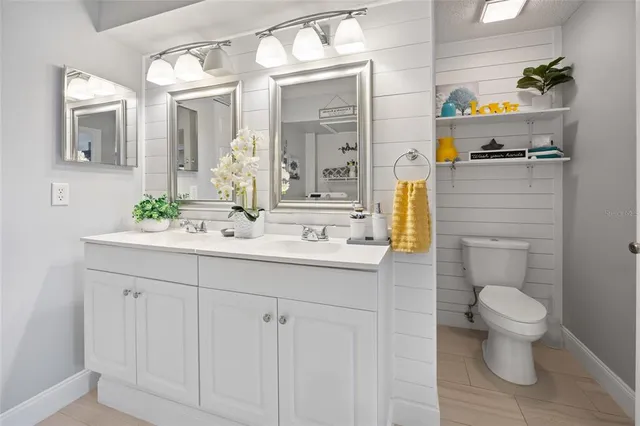 a bathroom with a sink a toilet and mirror