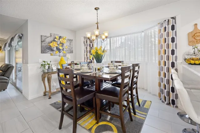 a view of a dining room with furniture and chandelier