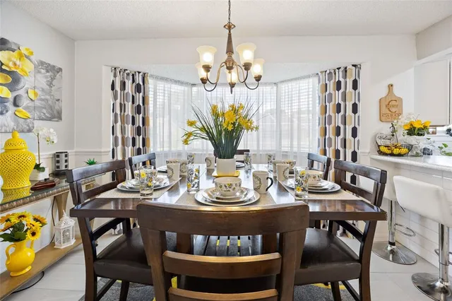 a view of a dining room with furniture and chandelier