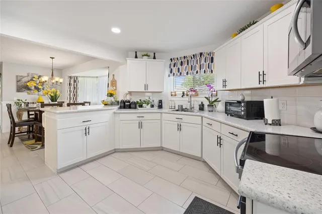 a kitchen with a sink window and cabinets