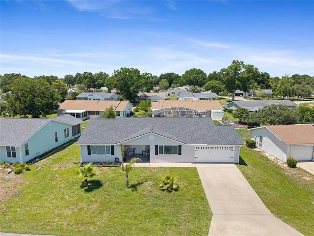 an aerial view of a house with big yard