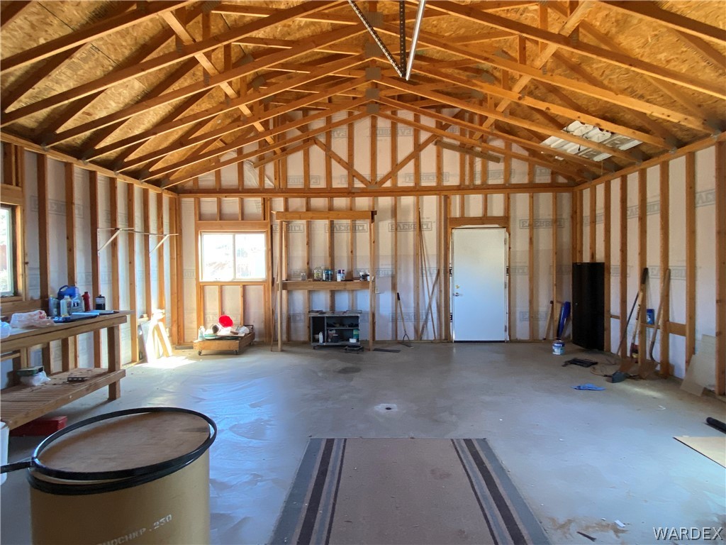 9095 Elliott Ridge Road Kingman, AZ 86401 - Photo 11 of 54 a view of an empty room with a fireplace and a window