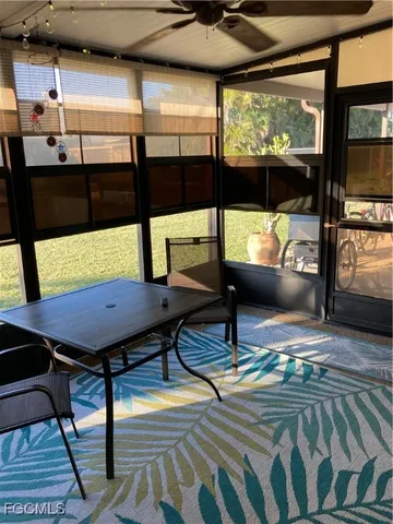 a view of a hallway with furniture and a window