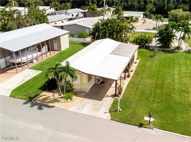 a view of a backyard with plants and patio