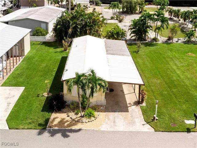 an aerial view of a house with yard patio and swimming pool