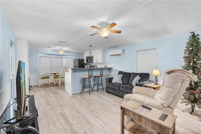 a living room with lots of furniture and kitchen view