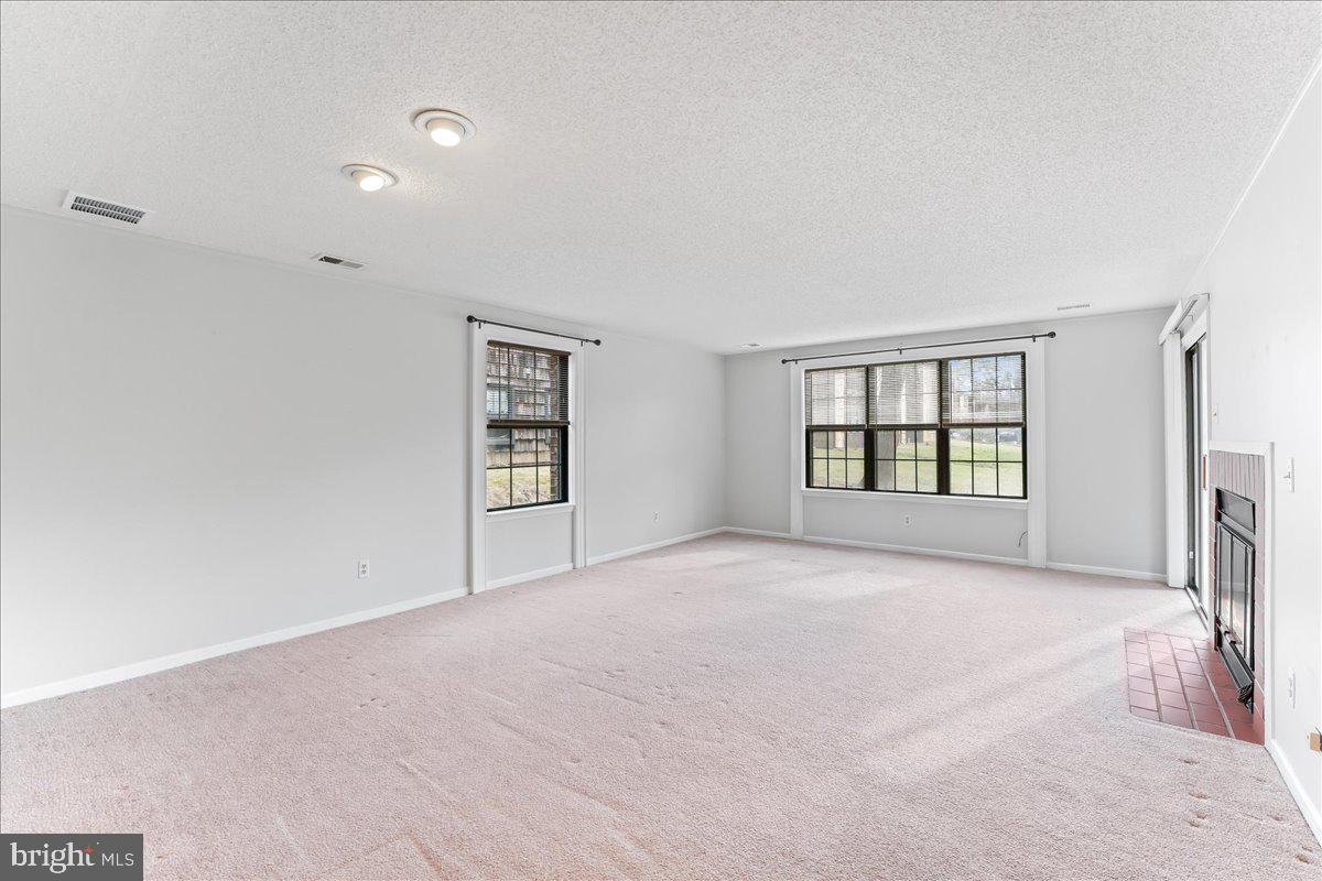 44 Witherspoon Court, Unit 137 Chesterbrook, PA 19087 - Photo 10 of 26 a view of an empty room with a window and fireplace