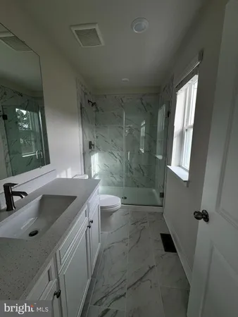 a bathroom with double vanity sink and mirror