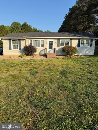 a view of house with a yard