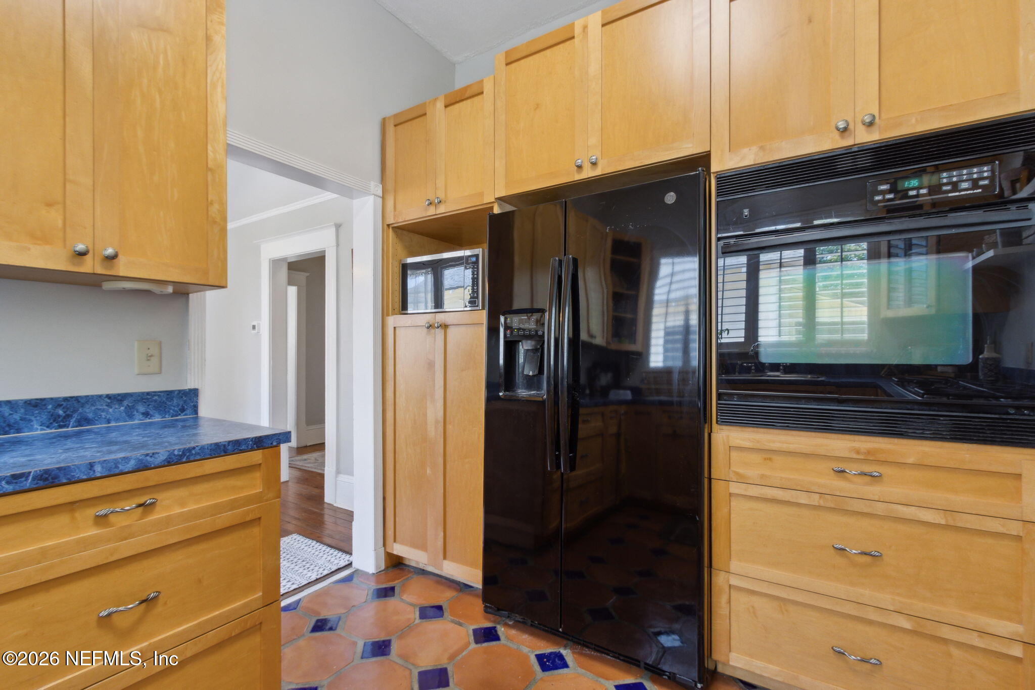 2974 Gilmore Street Jacksonville, FL 32205 - Photo 12 of 28 a kitchen with stainless steel appliances kitchen island granite countertop a refrigerator and a stove
