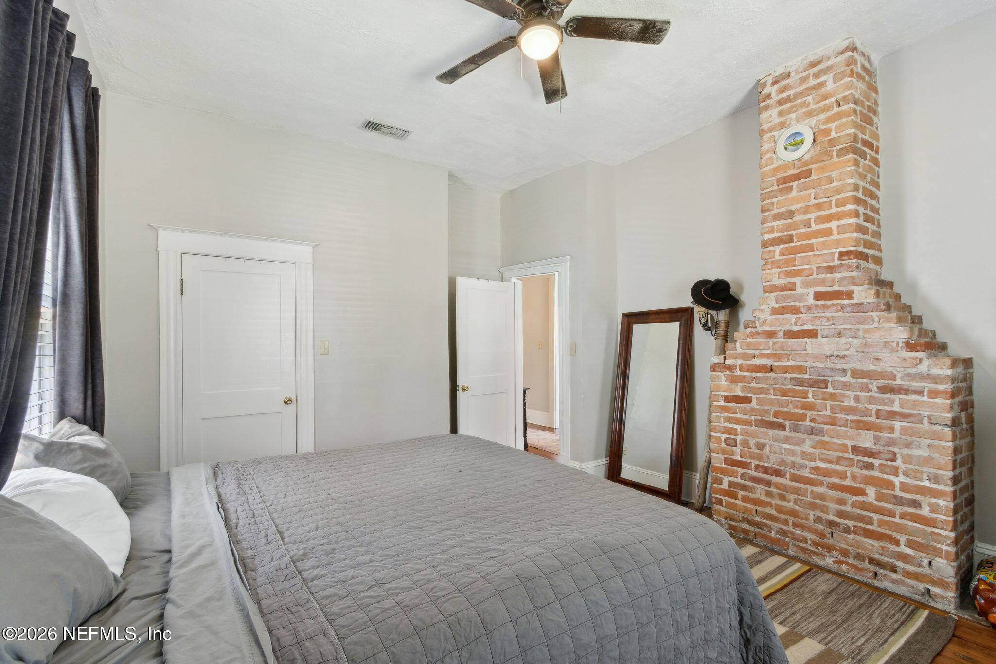 2974 Gilmore Street Jacksonville, FL 32205 - Photo 15 of 28 a bedroom with a bed and a chandelier