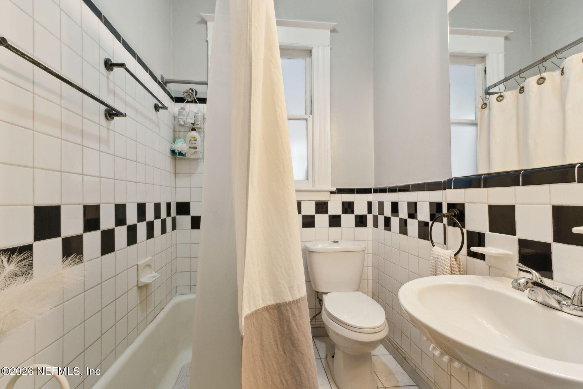 2974 Gilmore Street Jacksonville, FL 32205 - Photo 18 of 28 a white toilet sitting next to a bathroom sink