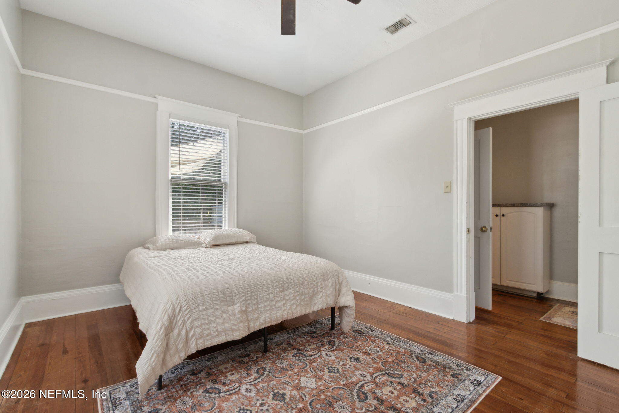 2974 Gilmore Street Jacksonville, FL 32205 - Photo 19 of 28 a bedroom with a bed and wooden floor