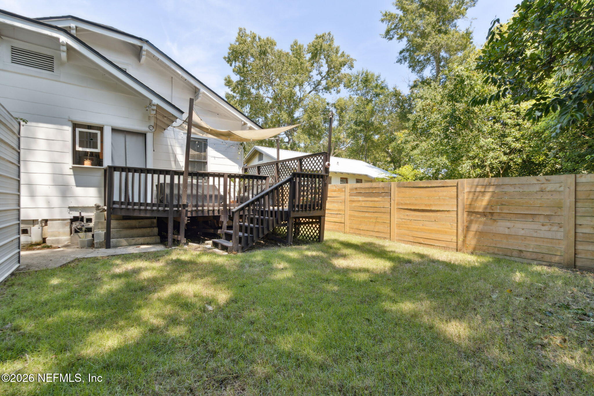 2974 Gilmore Street Jacksonville, FL 32205 - Photo 27 of 28 a view of a house with wooden fence and a large tree